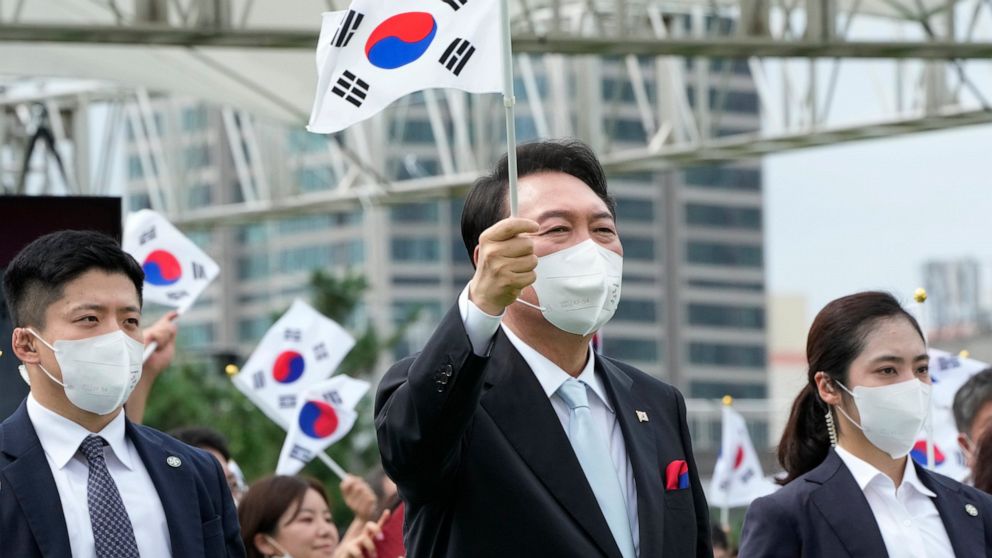 South Korean President Yoon Suk Yeol waves a national flag during a ceremony to celebrate Korean Liberation Day from Japanese colonial rule in 1945, at the presidential office square in Seoul, South Korea, Monday, Aug. 15, 2022. (AP Photo/Ahn Young-j
