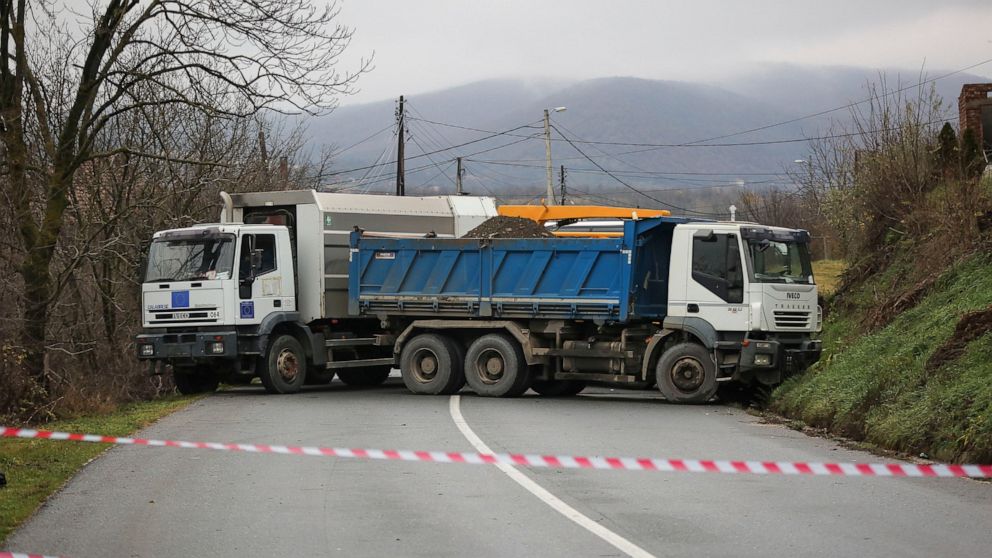 Heavy vehicles remain parked by local Serbs block the road in the village of Rudare, in northern Kosovo on Monday, Dec. 12, 2022. Barricades erected by local Serbs in the north of Kosovo remained up on Monday for the third consecutive day, despite ca
