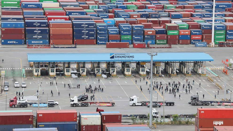 Members of the Cargo Truckers Solidarity of the Korean Confederation of Trade Unions gather in front of a shipping port in Gwangyang, South Korea, Tuesday, June 14, 2022. A weeklong strike by thousands of truckers in South Korea has triggered major d