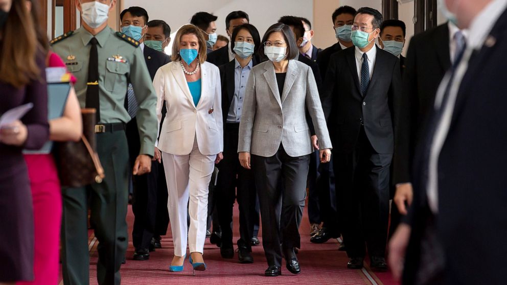 In this photo released by the Taiwan Presidential Office, U.S. House Speaker Nancy Pelosi, center left, and Taiwanese President President Tsai Ing-wen arrive for a meeting in Taipei, Taiwan, Wednesday, Aug. 3, 2022. U.S. House Speaker Nancy Pelosi, m