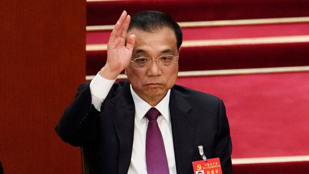 FILE - Chinese Premier Li Keqiang raises his hand to vote at the closing ceremony of the 20th National Congress of China's ruling Communist Party at the Great Hall of the People in Beijing on Oct. 22, 2022. Li praised the Hong Kong government's effor