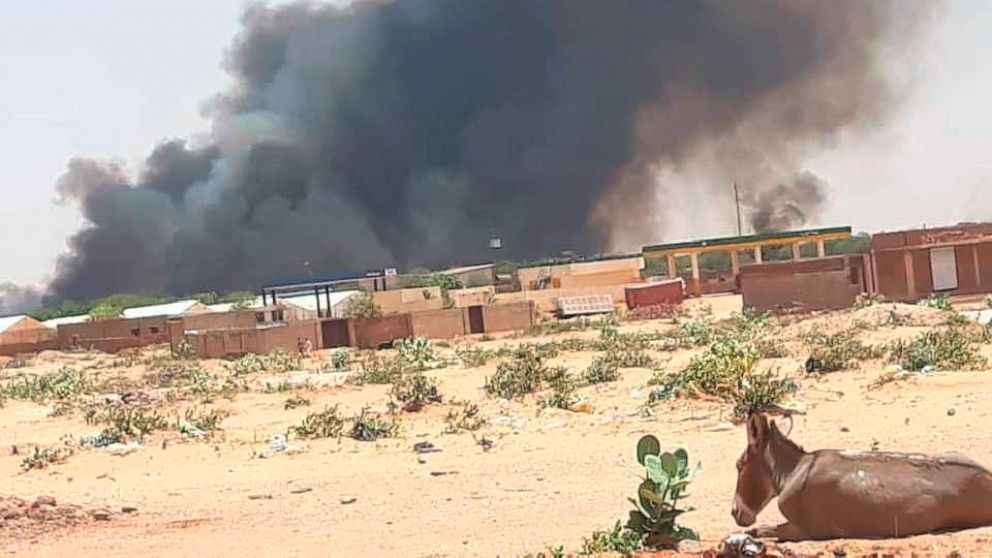 This photo provided by Organization for the General Coordination of Camps for Displaced and Refugees, smoke rises from Abu Zar camp for displaced persons in West Darfur, Sudan, on Tuesday, April 6, 2021. The death toll from tribal violence in Sudan’s