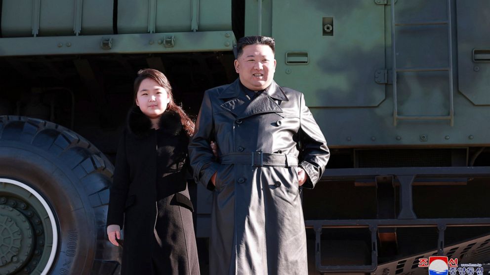 This undated photo provided on Nov. 27, 2022, by the North Korean government shows North Korean leader Kim Jong Un, right, and his daughter, left, posing for a photo, in front of a military truck with what it says a Hwasong-17 intercontinental ballis