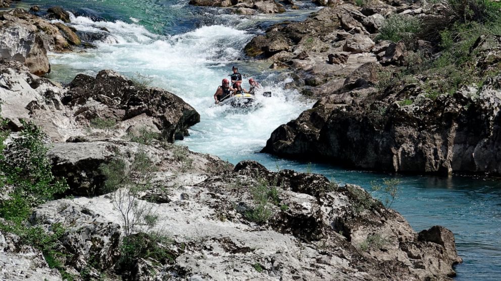 People rafting in a small rubber boat along the Neretva river near the town of Konjic, Bosnia, Saturday, July 2, 2022. It took a decade of court battles and street protests, but Balkan activists fighting to protect some of Europe's last wild rivers h