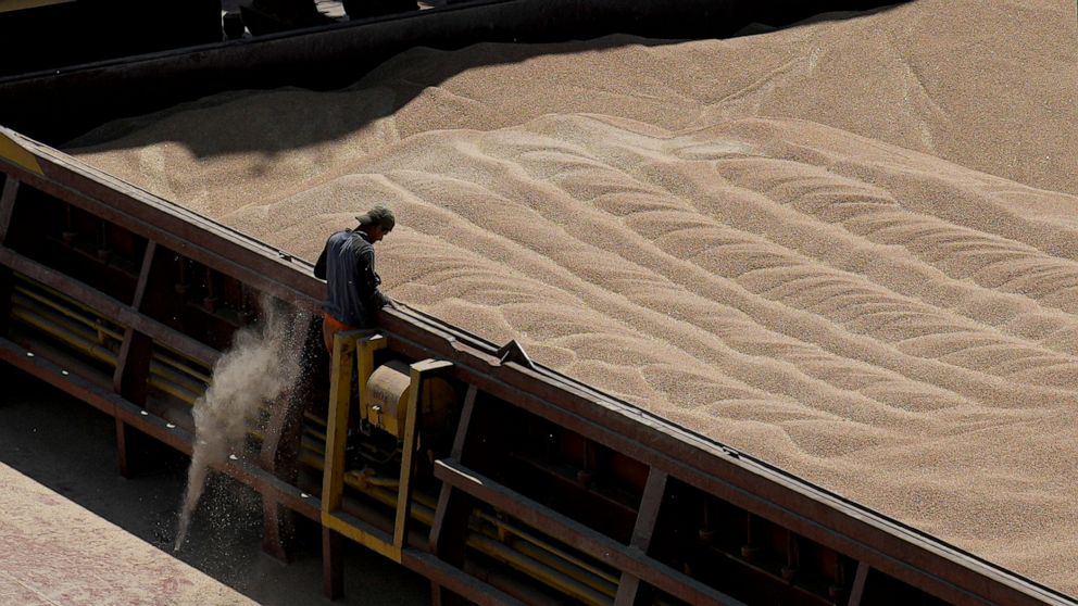 An employee of the Romanian grain handling operator Comvex oversees the unloading of Ukrainian cereals from a barge in the Black Sea port of Constanta, Romania, Tuesday, June 21, 2022. While Romania has vocally embraced the ambitious goal of turning 