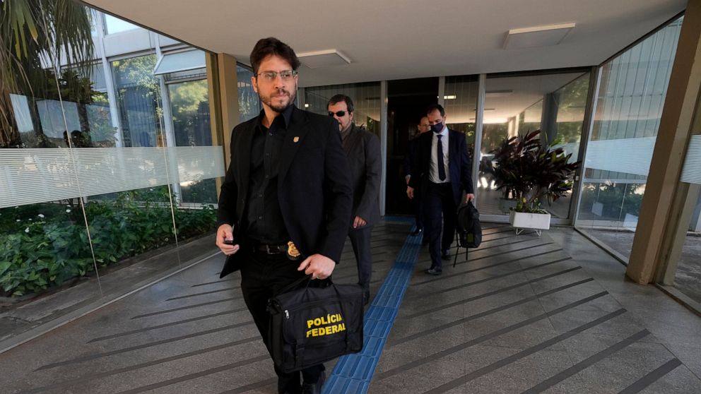 Federal police leave the headquarters of the Education Ministry after searching for evidence connected to the work of former Education Minister Milton Ribeiro in Brasilia, Brazil, Wednesday, June 22, 2022. Ribeiro was arrested on Wednesday in connect