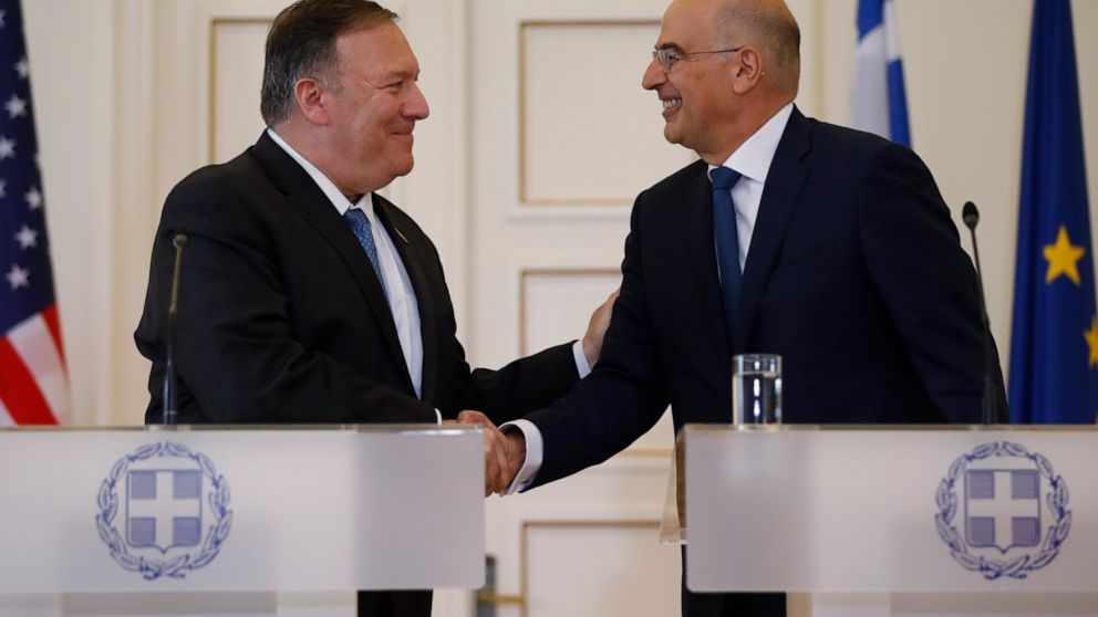 Greek Foreign Minister Nikos Dendias, right, shakes hands withU.S. Secretary of State Mike Pompeo, right, following their joint news conference after their meeting at the Foreign Ministry in Athens, Saturday, Oct. 5, 2019. Pompeo is in Greece on the 