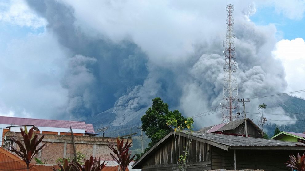 Mount Sinabung releases volcanic materials during an eruption as seen from a school yard in Karo, North Sumatra, Indonesia, Wednesday, July 28, 2021. The rumbling volcano on Indonesia’s Sumatra island on Wednesday shot billowing columns of ash and ho