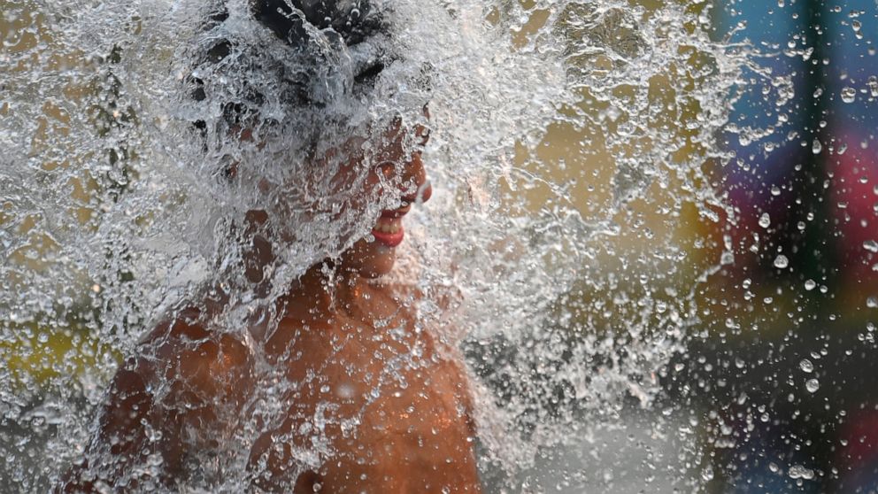 A child cools off amid a summer heat wave in Buenos Aires, Argentina, Friday, Jan. 14, 2022. (AP Photo/Mario De Fina)