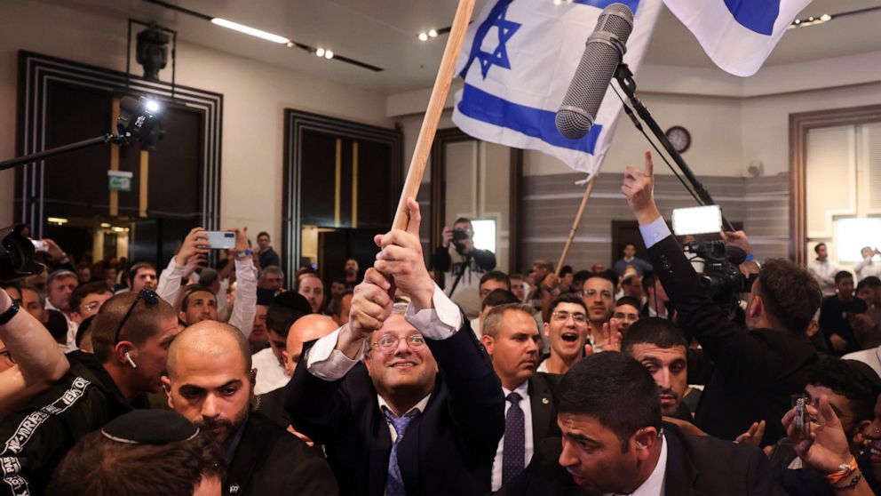 Israeli far-right lawmaker and the head of "Jewish Power" party, Itamar Ben-Gvir, waves the Israel flag after first exit poll results for the Israeli Parliamentary election at his party's headquarters in Jerusalem, Wednesday, Nov. 2, 2022. (AP Photo/