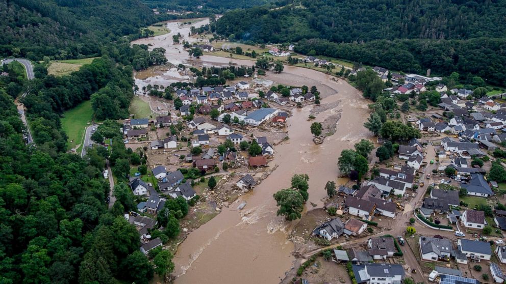 FILE - The Ahr river floats past destroyed houses in Insul, Germany, Thursday, July 15, 2021. Germany's national railway on Monday resumed train service to a western valley that was devastated by flooding in mid-July following extensive repair work. 
