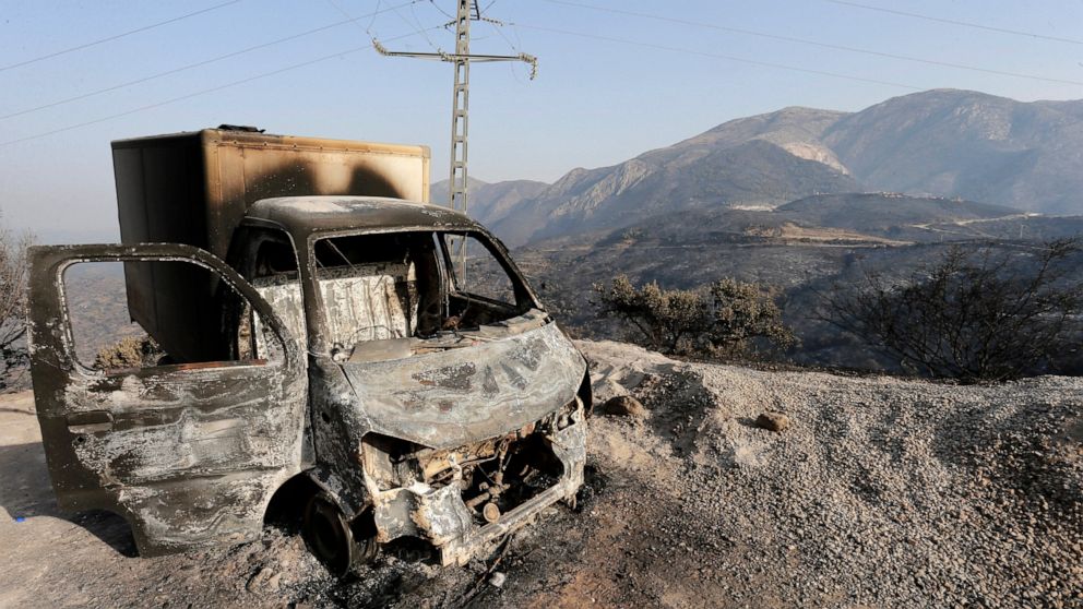 FILE - A charred truck is pictured after a fire near the village of Achlouf, in the Kabyle region, east of Algiers, Friday, Aug. 13, 2021. An Algerian court sentenced 49 people to death Thursday, Nov. 24, 2022 for the brutal mob killing of a painter 
