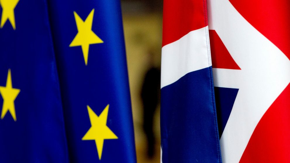 F|ILE - In this file photo dated Tuesday, Jan. 28, 2020, the British Union flag, right, and the EU flag, seen inside the atrium at the Europa building in Brussels. The number of Britons moving to live in European Union countries has soared since the 