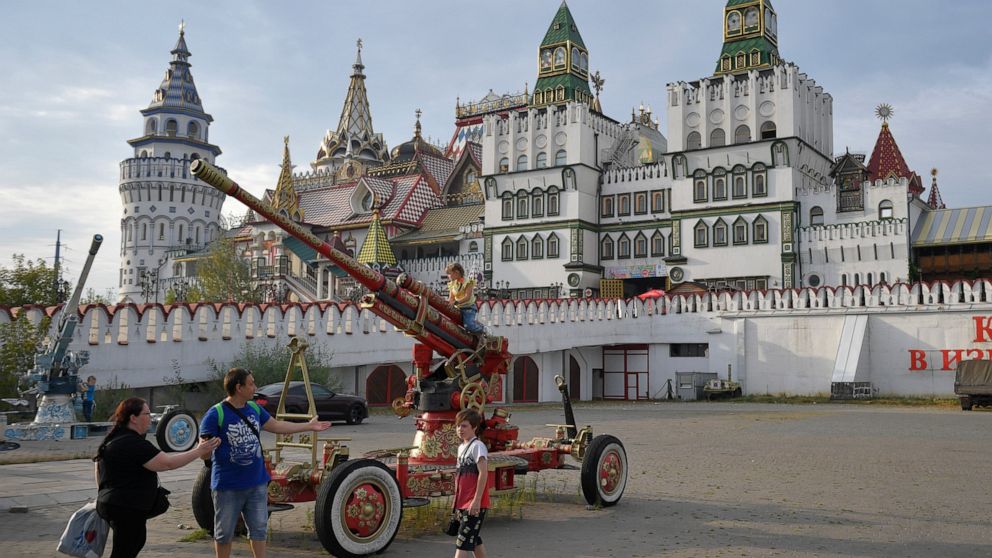 People walk at the Izmailovsky Kremlin in Moscow, Russia, Sunday, Aug. 21, 2022. Six months after Russia sent troops into Ukraine, there's little sign of the conflict on Moscow's streets and the capital's residents seem unconcerned about the economic