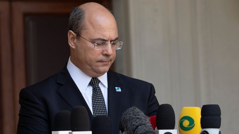 Rio de Janeiro Governor Wilson Witzel pauses as he speaks to journalists at the Laranjerias palace in Rio de Janeiro, Brazil, Tuesday, May 26, 2020. Brazil's Federal Police searched Witzel's official residence on Tuesday, part of an investigation int