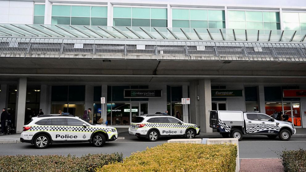 Australian Federal Police attend the Canberra Airport in Canberra, Sunday, Aug. 14, 2022, after a shooting incident. An Australian man is charged with three weapons offenses Monday, Aug. 15, after he allegedly used a handgun inside the Canberra Airpo