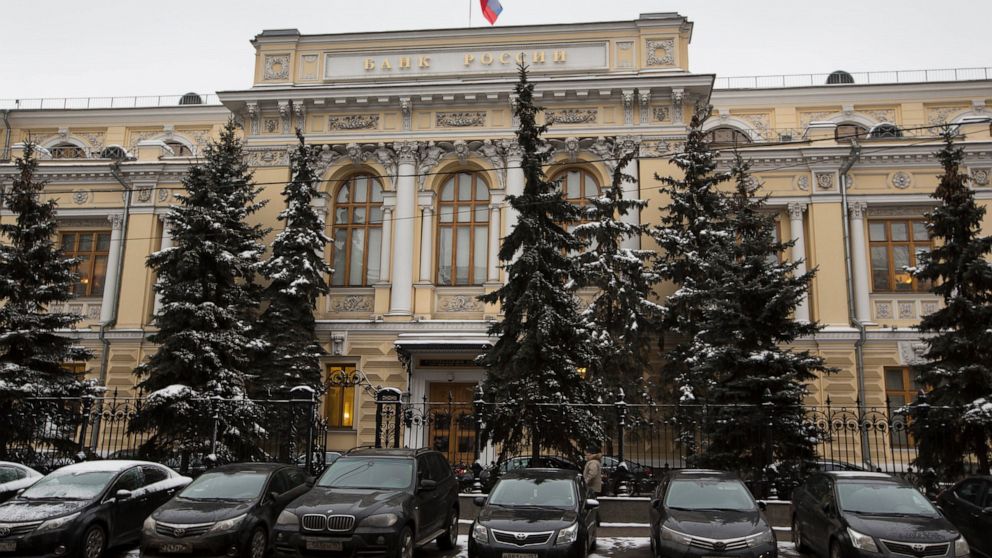 FILE - Cars are parked in front of Russia's Central Bank building in Moscow, Russia, Jan. 30, 2015. Prices for Russian credit default swaps — insurance contracts that protect an investor against a default — plunged sharply overnight after Moscow used