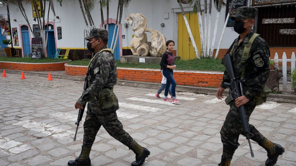 Soldiers patrol in Cantarranas, Honduras, Saturday, Nov. 27, 2021, one day ahead of the general elections. Political related violence prior to Sunday’s elections has reached unprecedented levels with close to 30 murders considered to have been motiva