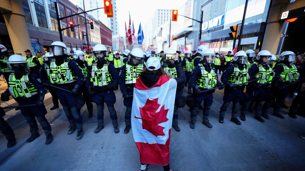 A protester confronts police during a demonstration, part of a convoy-style protest participants are calling "Rolling Thunder", Friday, April 29, 2022, in Ottawa. (Sean Kilpatrick/The Canadian Press via AP)