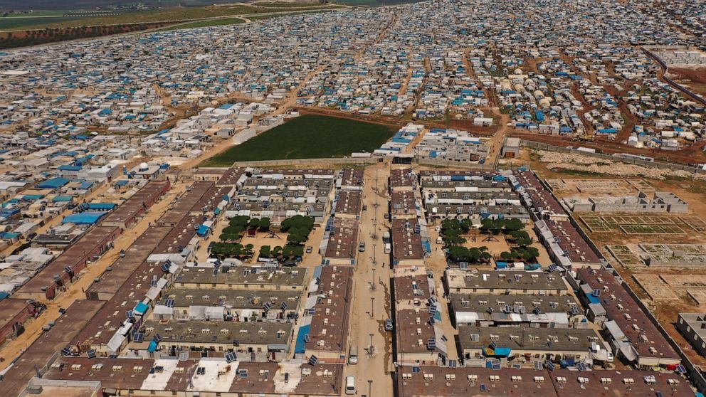 FILE - An aerial view shows a large refugee camp on the Syrian side of the border with Turkey, near the town of Atma, in Idlib province, Syria, April 19, 2020. Syrians in the last major rebel stronghold in the war-ton country are living in fear of th