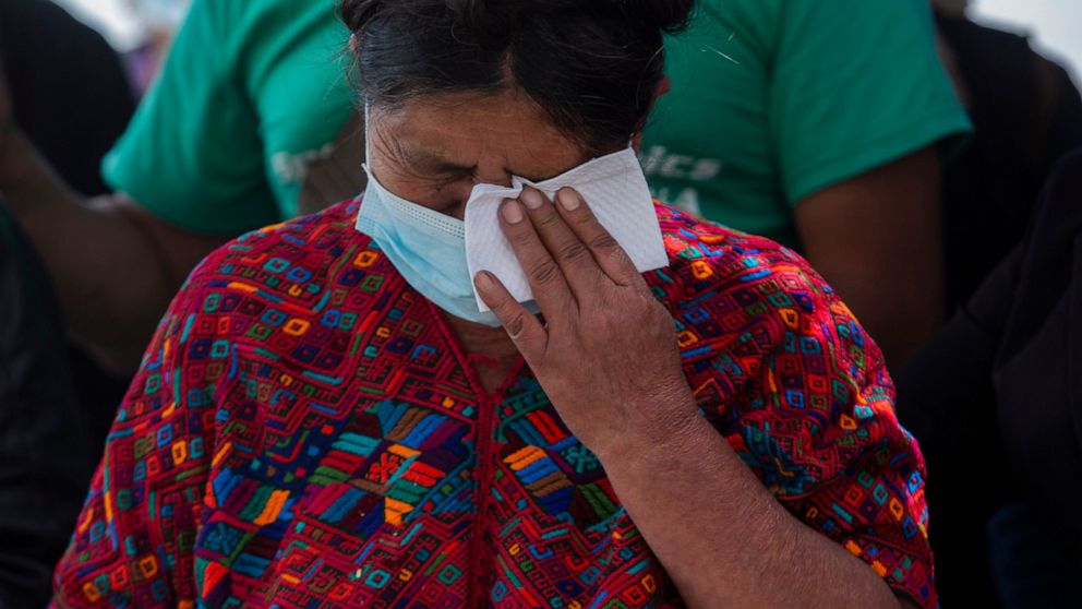 Manuela Coj Ixtos, the grandmother of Pascual Melvin Guachiac Sipac, cries as she watches his coffin arrive to the airport in Guatemala City, Friday, June 15, 2022. The 13-year-old was among a group of migrants who died of heat and dehydration in a t