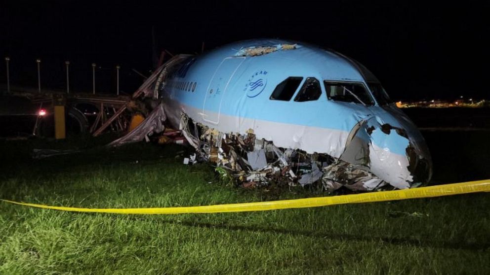 In this handout photo provided by the Civil Aviation Authority of the Philippines, a damaged portion of the Korean Air Lines Co. plane lies after it overshot the runway at the Mactan Cebu International Airport in Cebu, central Philippines, on Monday,
