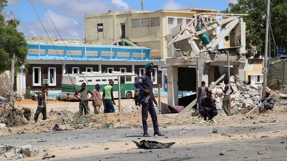 A Somali soldier guards the site of the bomb blast in Mogadishu Somalia, Wednesday April 28, 2021. At least seven people were killed and more than 11 others wounded when a vehicle exploded outside a police headquarters in Somalia's capital, police an