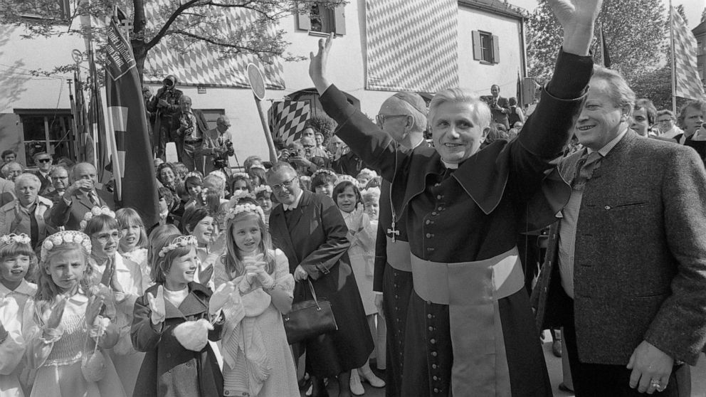 FILE - Joseph Ratzinger, the new archbishop of Munich and Freising, raises his arms to greet believers at his arrival in the Bavarian capital of Munich, Germany, on May 23, 1977. Pope Emeritus Benedict XVI, the German theologian who will be remembere