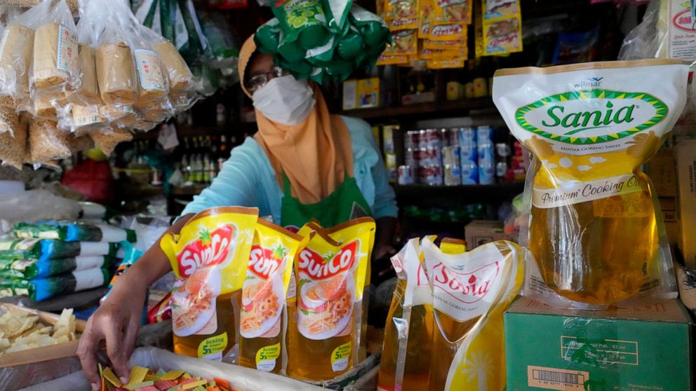 FILE - Packs of palm cooking oil are displayed at a stall at market in Jakarta, Indonesia, Sunday, April 17, 2022. Indonesia said Thursday, May 19, 2022, that it will lift a monthlong ban on palm oil export, citing improvements in the supply and dome