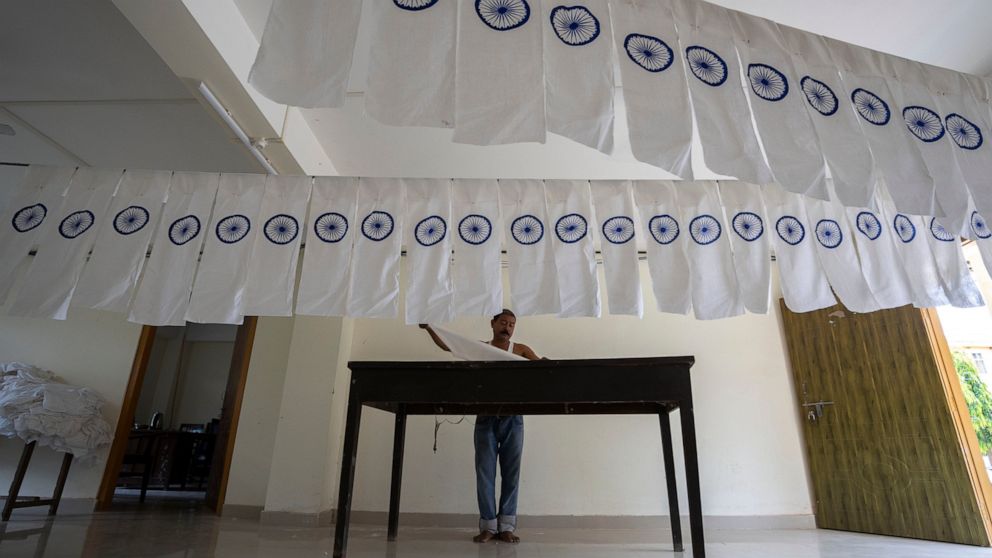FILE- A man works on an under-production Indian national flag to dry in an office ahead of Independence Day in Gauhati, in the northeastern state of Assam, Aug. 2, 2022. India marks 75 years of independence from British rule on Aug. 15. (AP Photo/Anu