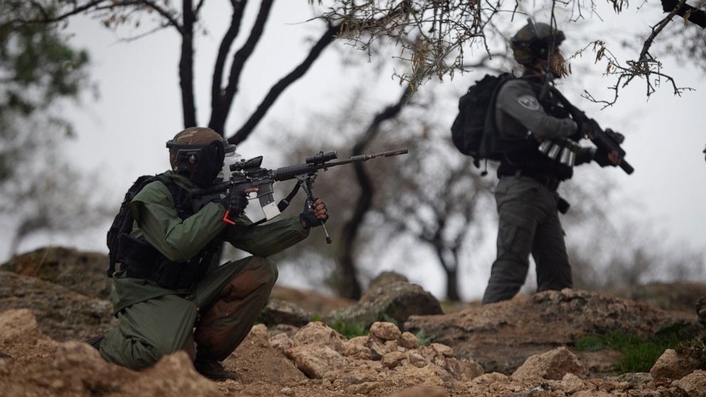 Israeli border policemen take position during clashes with Palestinian protesters as they a protest against Israeli settlements, in the village of Mughayer, near the West Bank city of Ramallah, Friday, Jan. 15, 2021. (AP Photo/Majdi Mohammed)