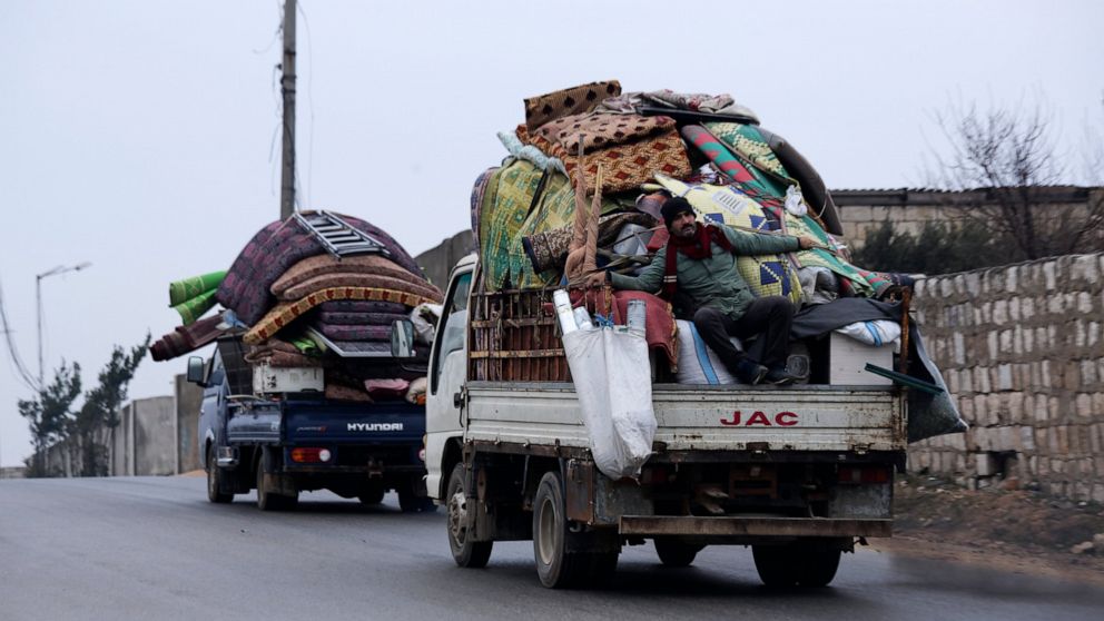 Syrians drive through the city of al-Mastouma, in Idlib province, as they flee a government offensive, Tuesday, Jan. 28, 2020. Syrian government forces have been on the offensive for more than a month in the northwestern Idlib province, the last rebe