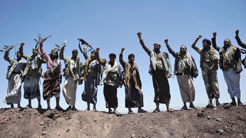 FILE - In this Sept. 22, 2014 file photo, Hawthi Shiite rebels chant slogans at the compound of the army's First Armored Division, after they took it over, in Sanaa, Yemen. Yemen’s war began in September 2014, when the Houthis seized the capital Sana