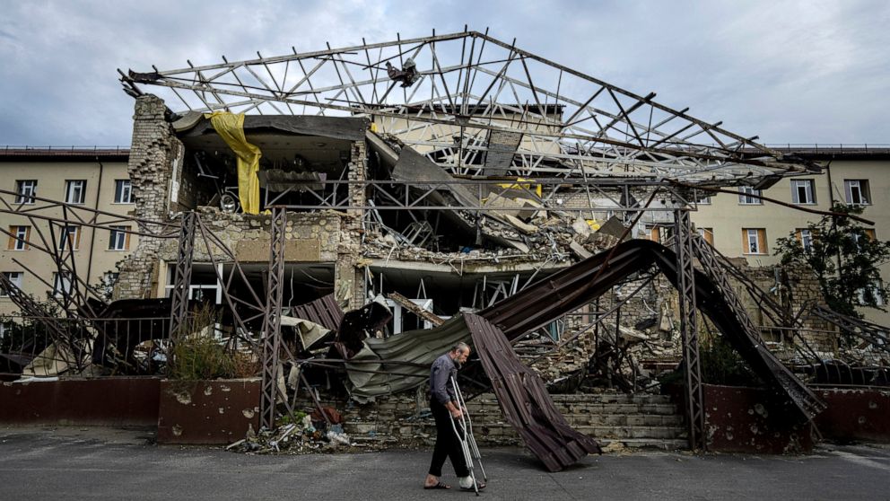 A patient walks past the surgery department which was destroyed after a Russian attack at the hospital in Izium, Ukraine, Saturday, Sept. 17, 2022. Medical staff at the Izium hospital in eastern Ukraine are fighting the memories of six deadly months 