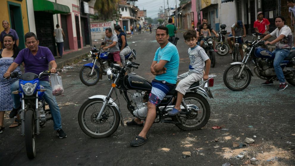 Residents assess the damage a day after clashes between Bolivarian National Guards and anti-government protesters in Urena, Venezuela, near the border with Colombia, Sunday, Feb. 24, 2019. A U.S.-backed drive to deliver foreign aid to Venezuela on Sa
