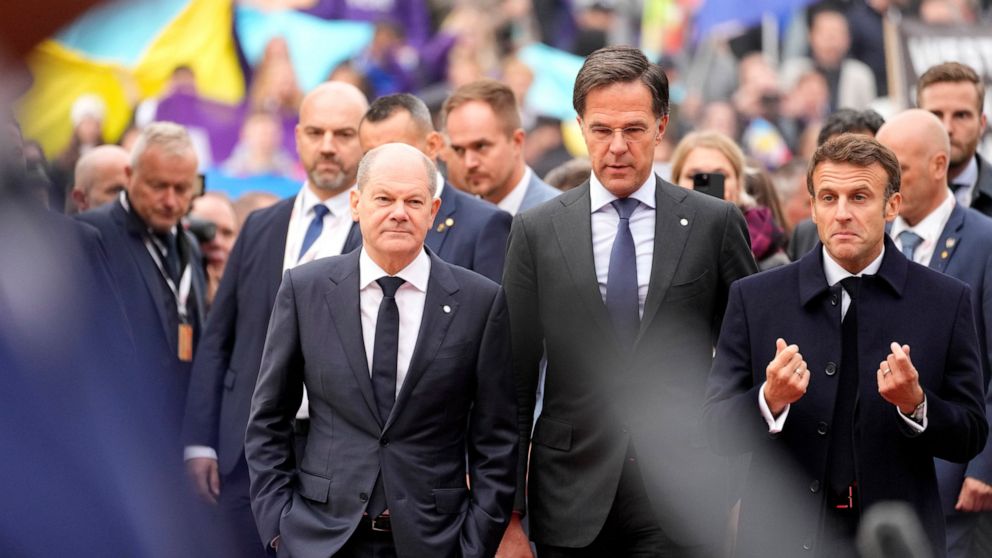 FILE - From left, Germany's Chancellor Olaf Scholz, Netherland's Prime Minister Mark Rutte and French President Emmanuel Macron arrive for an EU Summit at Prague Castle in Prague, Czech Republic, Friday, Oct 7, 2022. European Union leaders enter a cr