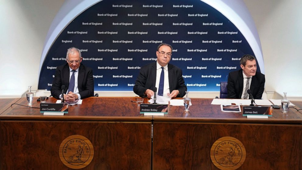 FILE - From left, Jon Cunliffe, Deputy Governor for Financial Stability, Andrew Bailey, Governor of the Bank of England, and James Bell, Executive Director for Communications are seated during the Bank of England's financial stability report press co