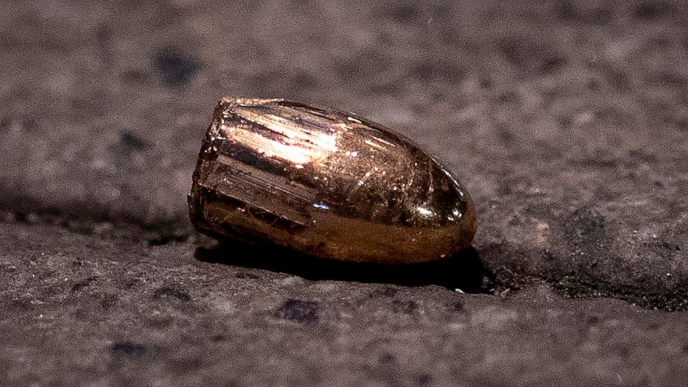 FILE - In this Feb. 19, 2020 file photo, a projectile lies on the sidewalk near a restaurant at the scene of a shooting in central Hanau, Germany. About one year ago a far right man shot nine people before he shot himself. Hanau will commemorate the 
