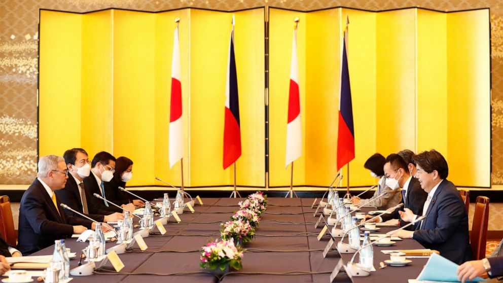Philippine Foreign Secretary Teodoro Locsin Jr., left, and Japanese Foreign Minister Yoshimasa Hayashi, right, speak during a meeting at the Iikura Guest House in Tokyo Saturday, April 9, 2022. (Rodrigo Reyes Marin/Pool Photo via AP)