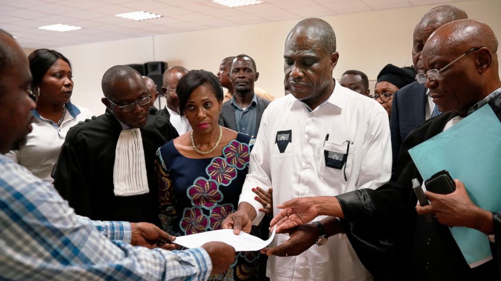 Accompanied by his wife and his lawyers, Congo opposition candidate Martin Fayulu receives the receipt after petitioning the constitutional court following his loss in the presidential elections in Kinshasa, Congo, Saturday Jan. 12, 2019. The ruling 