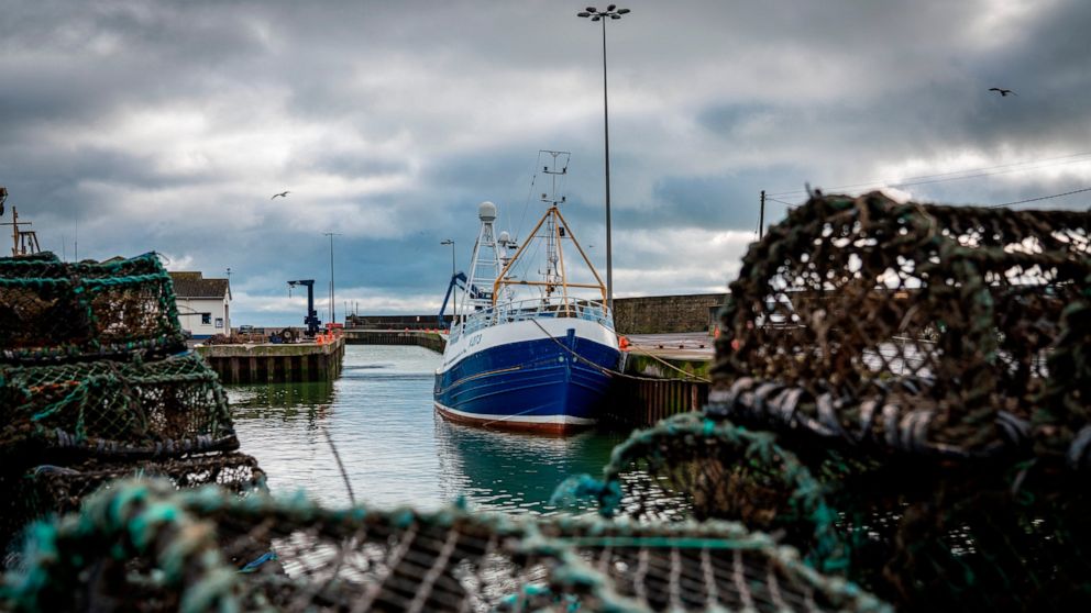 FILE- In this Tuesday, Jan. 28, 2020 file photo, a fishing vessel is docked at Kilkeel harbor in Northern Ireland. Fishing has become one of the main stumbling blocs in the Brexit negotiations for a new trade deal between the European Union and the U
