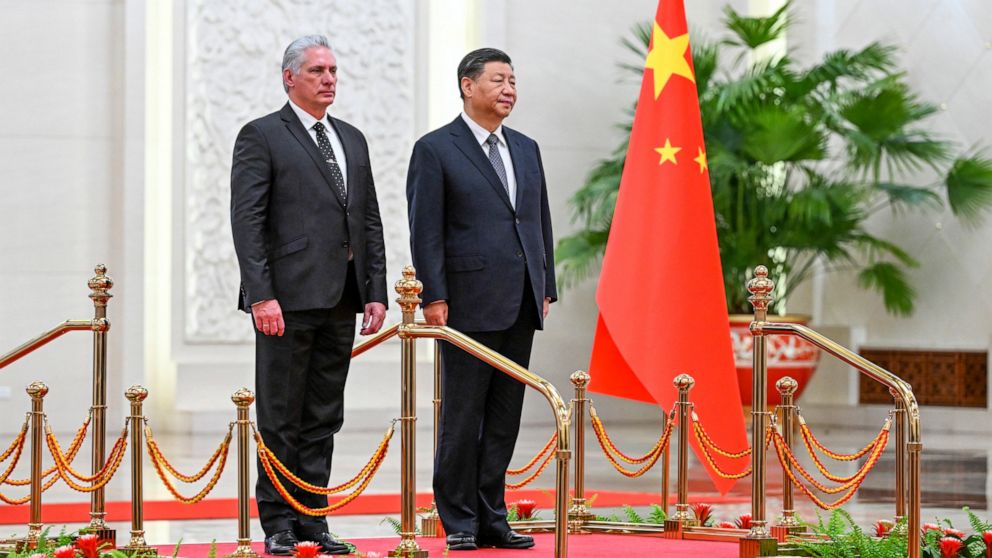 In this photo released by China's Xinhua News Agency, Cuba's President Miguel Diaz-Canel Bermudez, left, and Chinese President Xi Jinping stand during a welcome ceremony at the Great Hall of the People in Beijing, Friday, Nov. 25, 2022. Chinese Presi