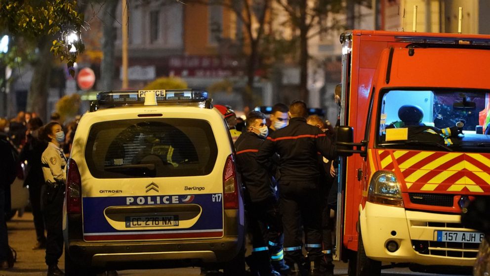 Police officers and rescue workers block the access to the scene after a Greek Orthodox priest was shot Saturday Oct.31, 2020 while he was closing his church in the city of Lyon, central France. The priest, a Greek citizen, is in a local hospital wit