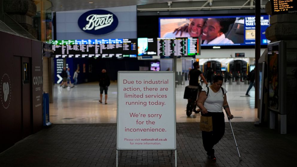 A strike sign is displayed by an entrance at Waterloo train station, in London, during a railway workers strike, Thursday, June 23, 2022. Millions of people in Britain faced disruption Thursday as railway staff staged their second national walkout th