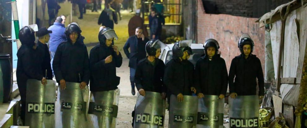 In this Saturday, Jan. 5, 2019 photo, police form a security cordon after a policeman was killed trying to defuse an explosive device near a church, in a residential district of Cairo, Egypt. The blast came just two days before the Orthodox Coptic Ch