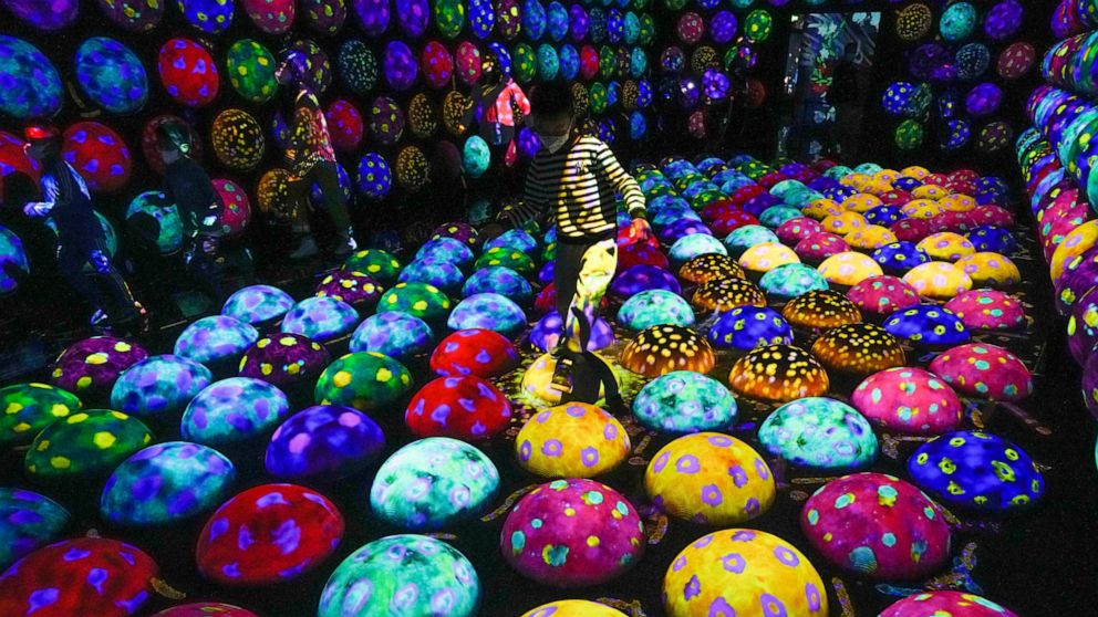 Children playing on digital art installation titled "The bouncing balls rotate fast in the caterpillar's house"opening time "teamLab Massless" museum in Beijing, Monday, December 26, 2022. "teamLab Massless" by Tokyo-based art collective tea
