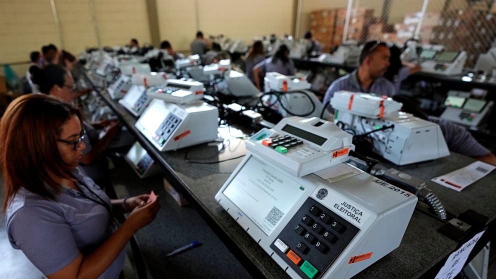 FILE - Electoral Court employees work on the final stage of sealing electronic voting machines in preparation for the general election run-off in Brasilia, Brazil, Oct. 19, 2022, ahead of the Oct. 30 second round vote. Valdemar Costa, president of th