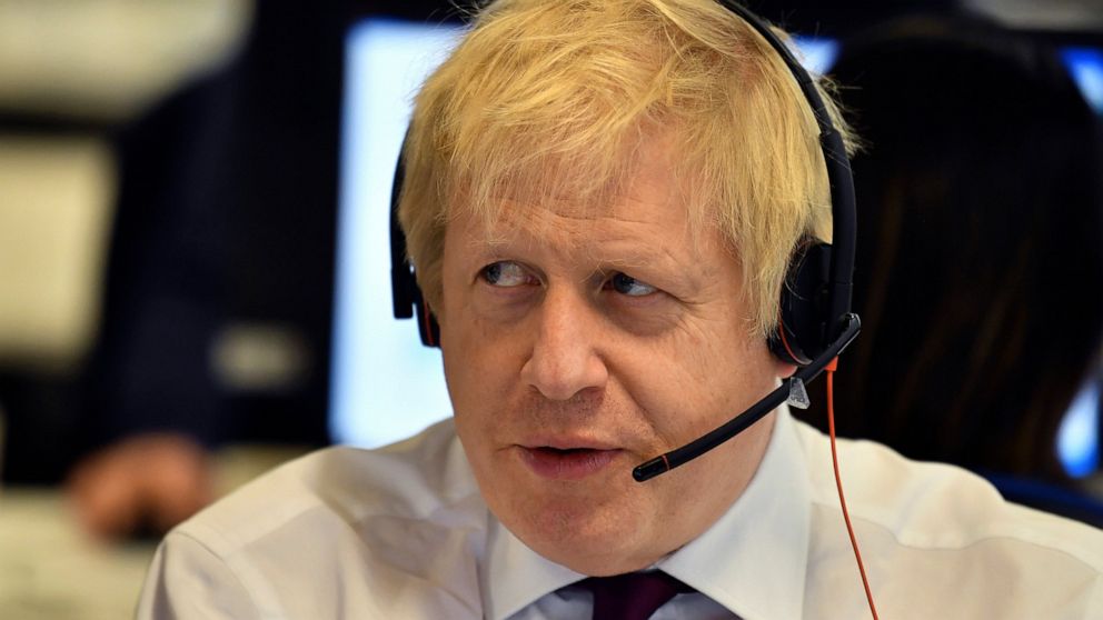 Britain's Prime Minister Boris Johnson, speaks to a caller on the phone, at the Conservative Campaign Headquarters Call Centre, while on the General Election trail, in central London, Sunday, Dec. 8, 2019. Britain goes to the polls on Dec. 12. (Ben S