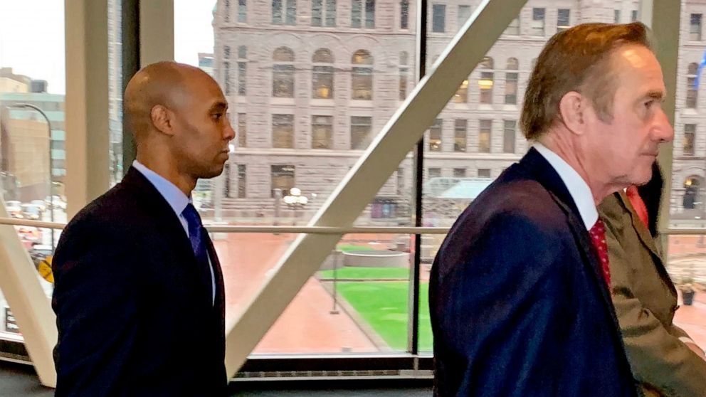 Former Minneapolis police officer Mohamed Noor, left, arrived with his defense attorneys Peter Wold, center, and Thomas Plunkett, right, partially hidden, on April 17, 2019, before another day of testimony in Noor's murder and manslaughter trial in M