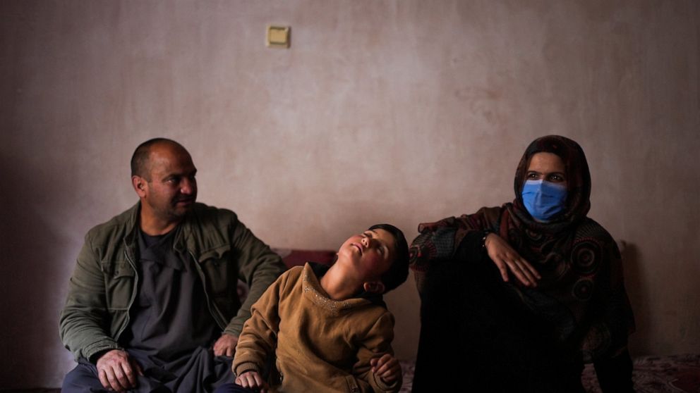 Sanam, a bacha posh, a girl living as a boy, sits next to her mother and father during an interview in their house, in Kabul, Afghanistan, Dec. 7, 2021. In the heavily patriarchal, male-dominated society of Afghanistan, where women and girls are usua